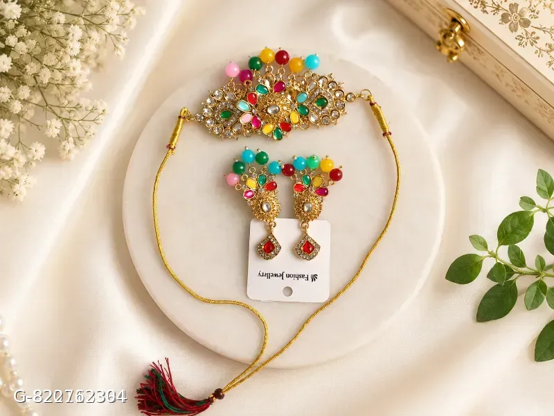 This gold-plated Kundan choker set features multicolored beads and artificial stones, resembling traditional Indian bridal jewelry